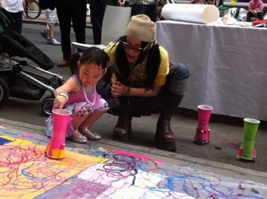 Future Parsons recruit painting with the ColorBot at The Parsons Festival 2011 Block Party, video still: Geoffry Gertz.